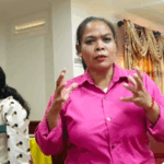 Ms Nguon Veasna explaining something, she is focused.