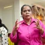 Ms Nguon Veasna explaining something, she is focused.