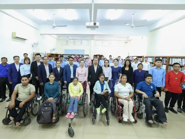 a group of people including those with disabilities posing for the camera.