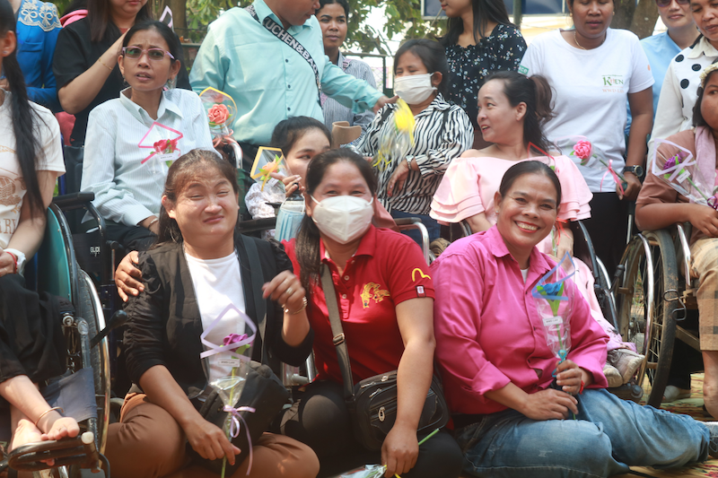 Group of women with disabilities smiling for a group picture.