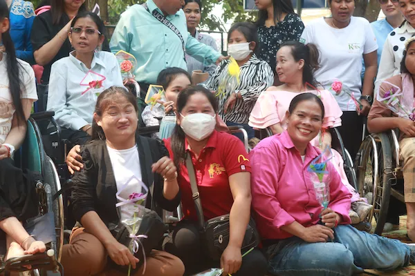 Group of women with disabilities smiling for a group picture.