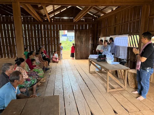 people sitting on wooden floor listening to trainers