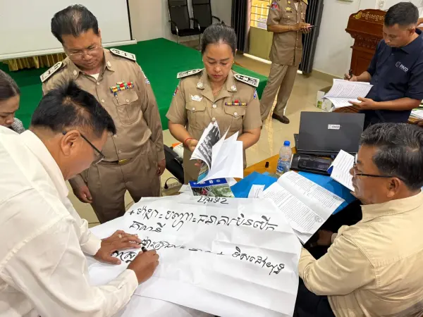 a group of people working on a flip chart.