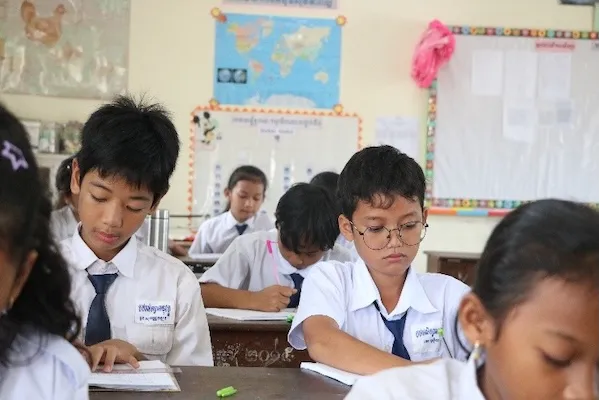 Mr. Chhi Piseth writing in classroom