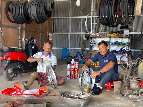 Two men working in a motor repair shop.