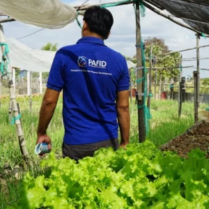 A man wearing a blue PAfID t-shirt.