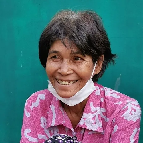 Woman seated and smiling.